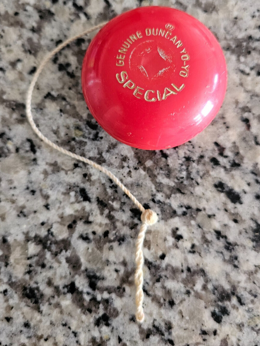 Vintage red plastic Duncan Special Yo-Yo with embossed gold lettering